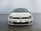 the front of a white vw golf parked in a room