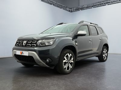 the grey dacia is parked in a large room with white walls