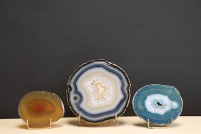 three pieces of agite are sitting on a table with a black background