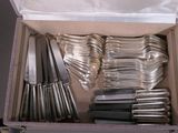 a lot of silverware in a box on the table