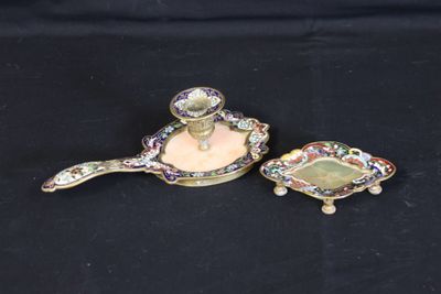 two pieces of jewelry sitting on top of a black surface