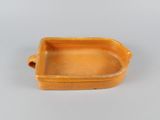 an orange rectangular dish with handles and handles on a white surface