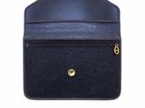 a black purse with a gold clasp on the front of it