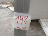 a sign on the side of a metal pole that has a sticker attached to it