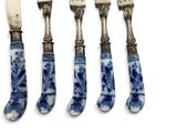 four pieces of blue and white chinaware with a silver handle