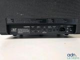 a close up of a black speaker on top of a table