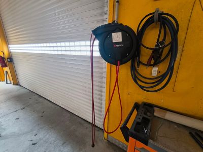 an image of a garage with a hose attached to the side of the garage door