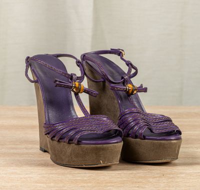 an image of a pair of purple shoes on a wooden table