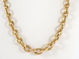 a close up of a gold chain necklace on a mannequin mannequin