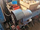 a machine that is sitting in a garage with other tools