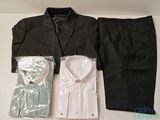 a suit, shirt, tie, and pants laid out on a table