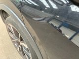a close up of a car ' s front bumper with a sticker on it