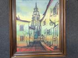 a picture of a painting on the wall above a laptop
