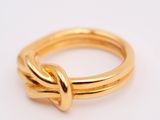 a close up of a gold ring on a white surface