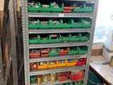 a rack of tools in a room with a lot of bins