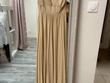 dress on a hanger in front of a mirror in a room