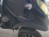 a scooter that is parked on the side of the street