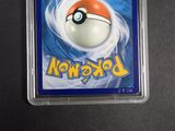 a pokemon card with a ball in it on a table