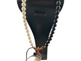 a close up of a mannequin with a necklace on it