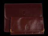 two brown leather wallets on a black background