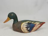 an image of a wooden duck sitting on top of a white surface