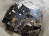 a lot of clothes in a plastic bag on a table