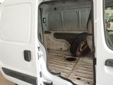 a white van with the door open and a tire in the back
