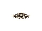 a close up of a brooch with pearls on a white background