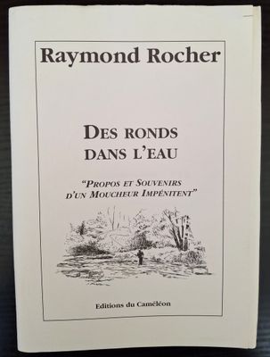 a white book with a drawing of a river and trees
