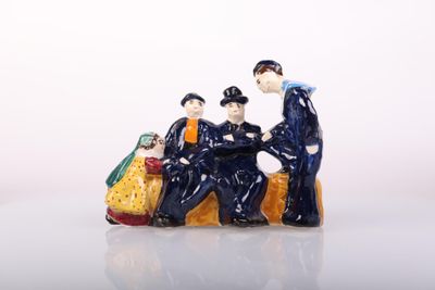 a figurine of a group of people sitting on a bench