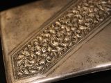 a silver plate that has a design on it