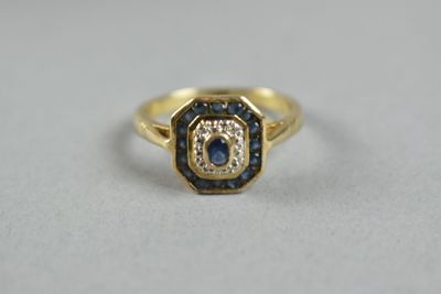 a close up of a gold ring with blue and white diamonds