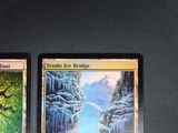 two cards are sitting on top of a table with a picture of a waterfall