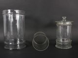 two glass jars sitting next to each other on a table
