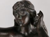 bronze statue of a child holding a bird on a white background