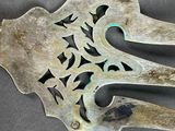 a silver spoon and a spoon rest on a table