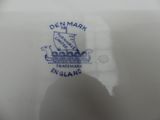 a close up of a plate with a boat on it