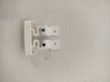 an overhead view of a pair of white door handles on a wall