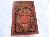 an old book sitting on a table with a white table cloth