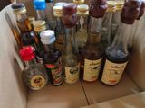 many bottles of alcohol in a box on the table