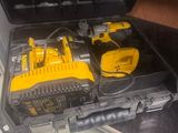 a yellow and black tool box with tools inside of it