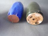 two blue and green vases sitting on a table