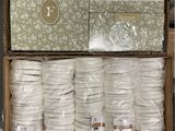 many rolls of white thread in a box