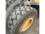 a large tire on the back of a construction vehicle