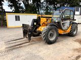 a small tractor that is parked in the dirt
