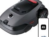 an image of a robotic lawn mower with a remote control