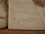 two stone sculptures that are sitting on a shelf