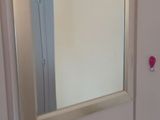 a bathroom with a sink, mirror, and toilet in it