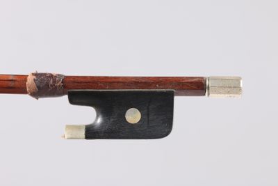 gros plan d'un archet de violon avec un morceau de bois qui en sort
