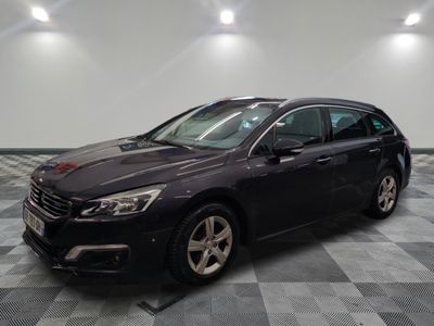 the black car is parked on a checkered tile floor